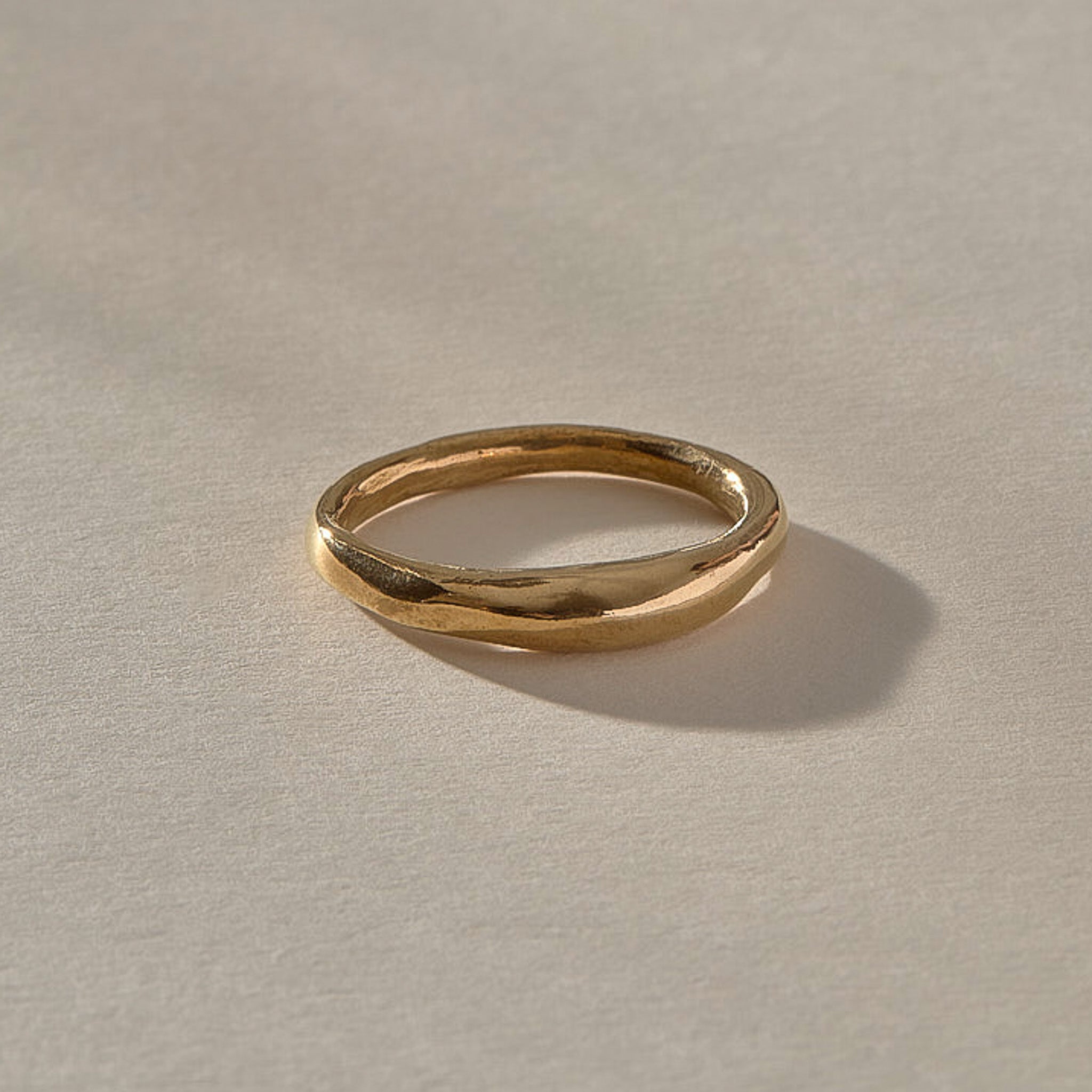 Wabi Ring in solid recycled gold, angled view of the softly undulating band