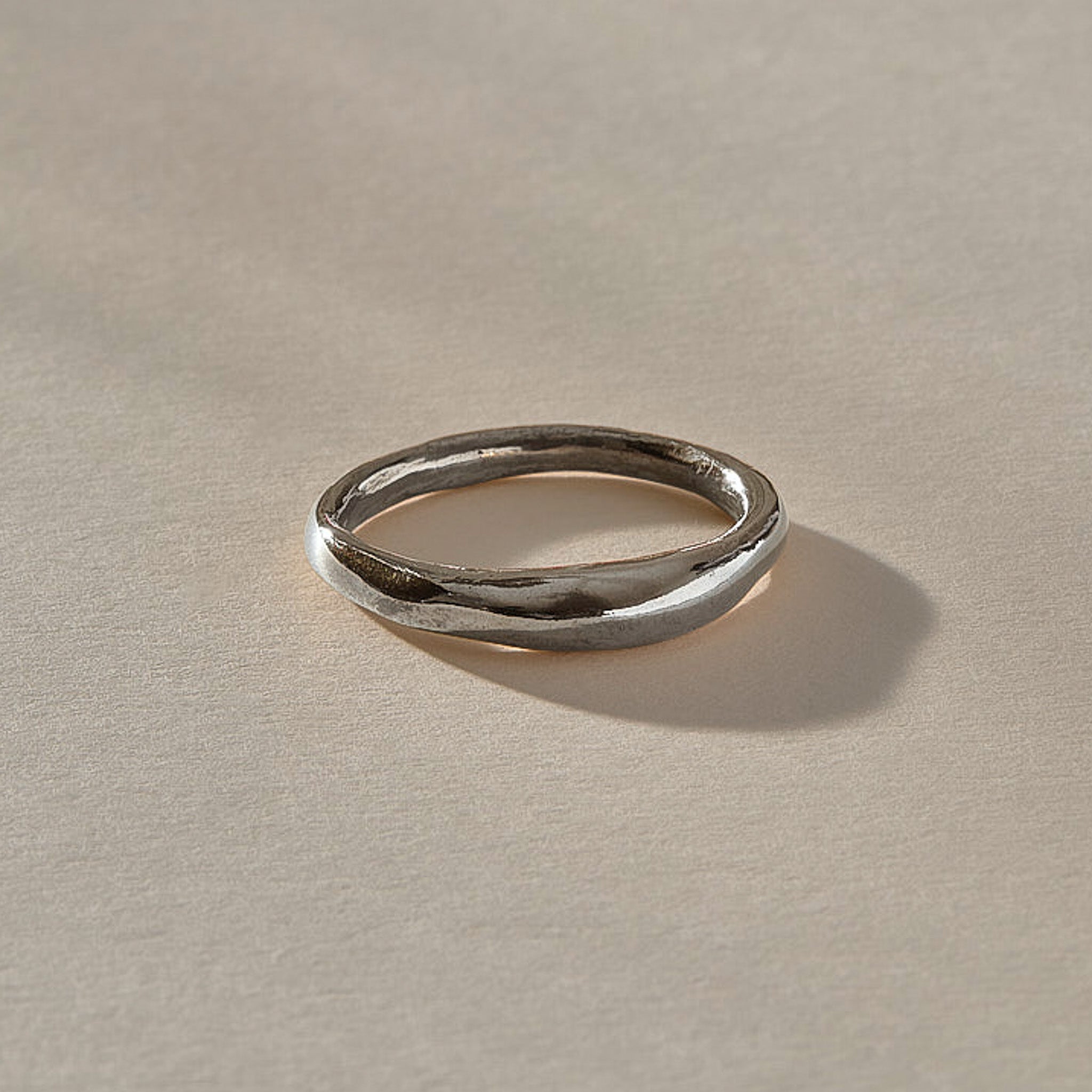 Wabi Ring in recycled sterling silver, angled view of the softly undulating band