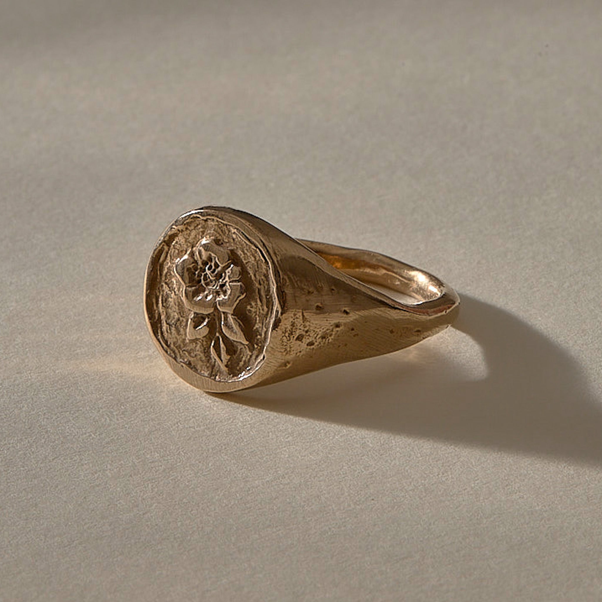 Wild Rose Ring in recycled bronze, angled view of the rose signet face