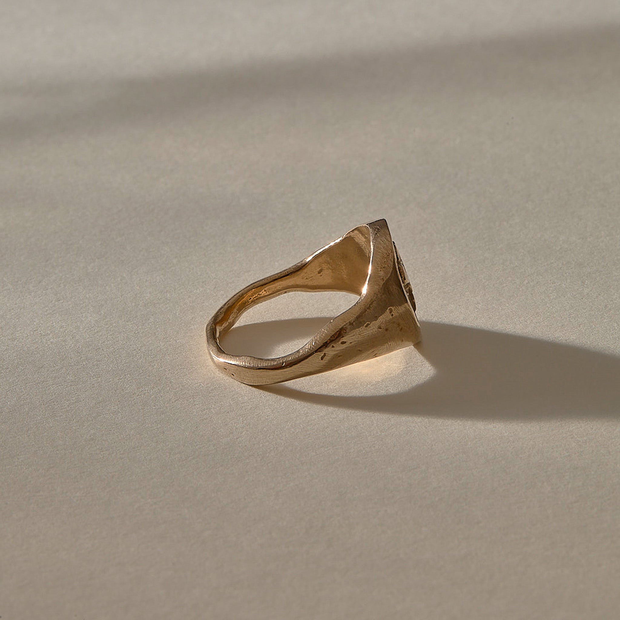 Wild Rose Ring in recycled bronze, side view of the band tapering to 2mm