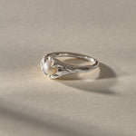 Yemayá Pearl Ring in silver at an angle, showing the wave-like texture around the pearl.