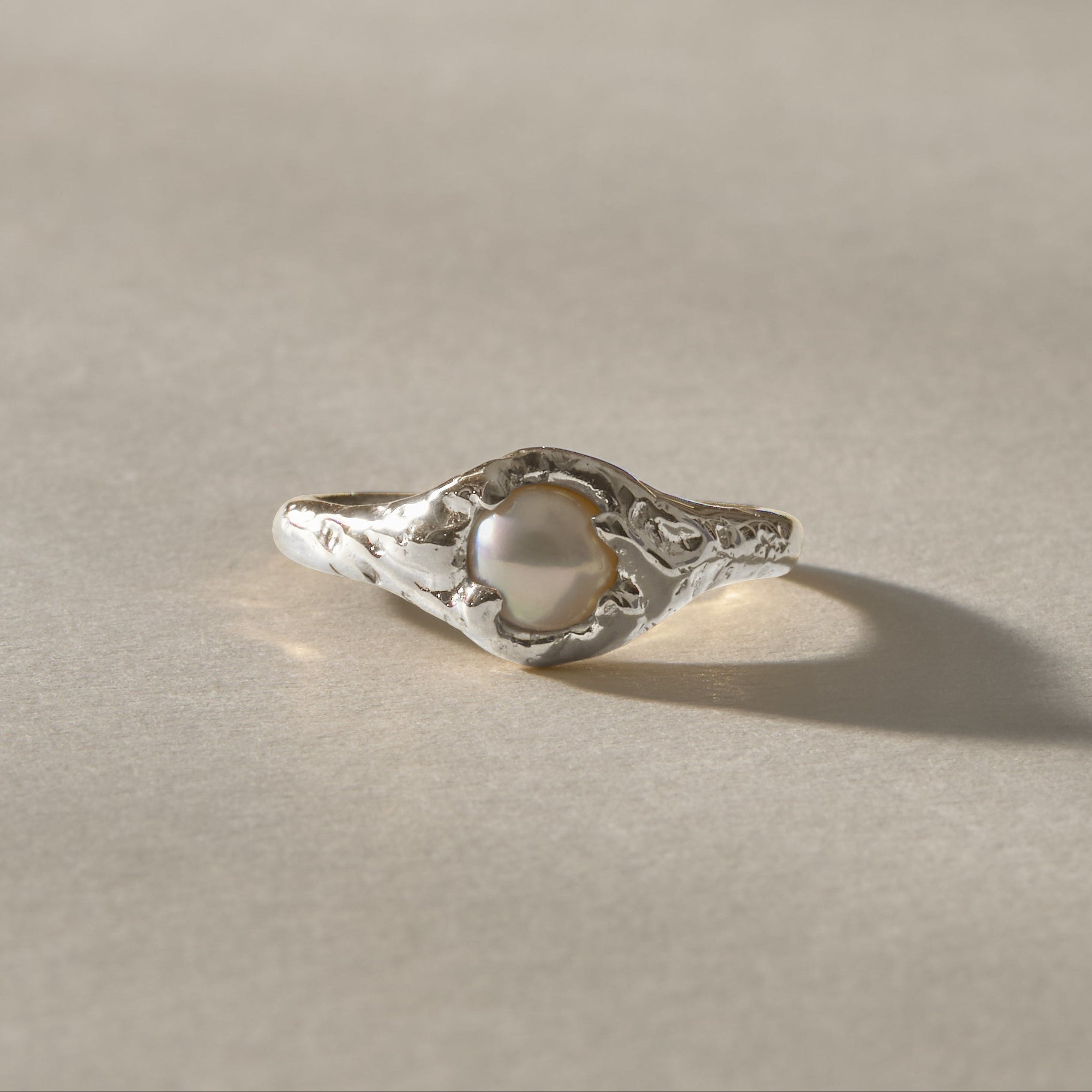 Yemayá Pearl Ring in recycled sterling silver, a white freshwater pearl crowning an organic, ocean-worn band.