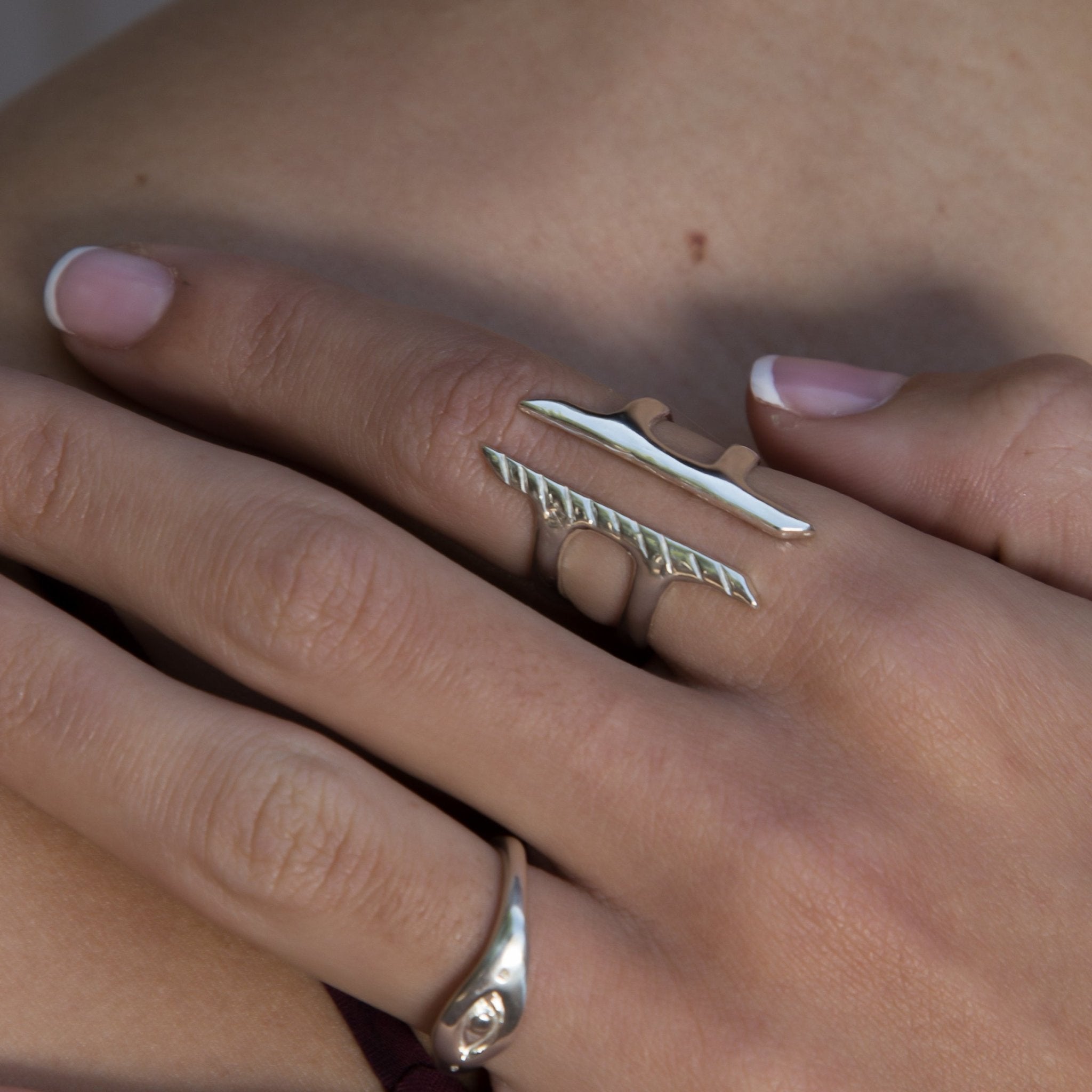 Hand wearing the Akash Shield Statement Ring in sterling silver.