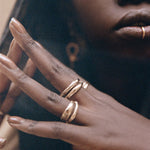 Model's hand near her face wearing the Magi Ring stacked with Catori Life rings