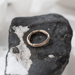 Magi Ring resting on a black and white stone