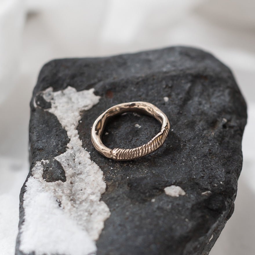 Magi Ring resting on a black and white stone