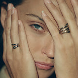 Model with her hands over her face, wearing the Stoned Serpent Ring stacked with Catori Life rings