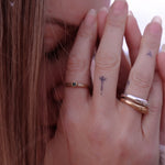 Model with her hands at her face, wearing the Wabi Ring stacked with Catori Life rings