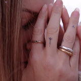 Model with her hands at her face, wearing the Wabi Ring stacked with Catori Life rings